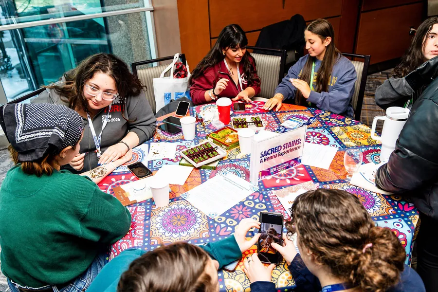 Hands at a craft table, seen from above.
